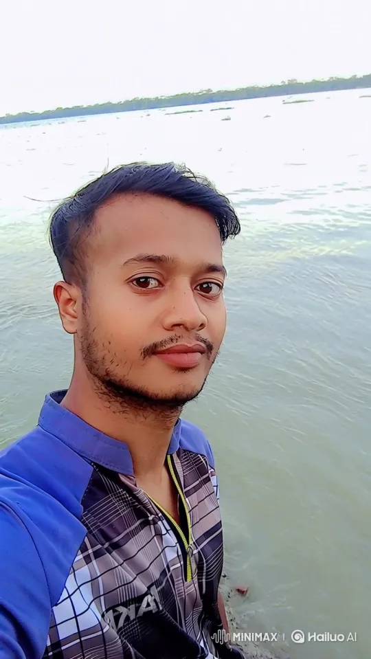 Young Man by Water: Slow Zoom and Smile – AI Generated Video | Hailuo AI