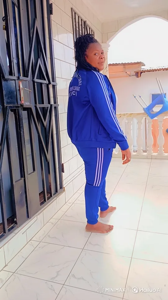 Woman Enters Red Sedan on Balcony - Tracking Shot – AI Generated Video | Hailuo AI