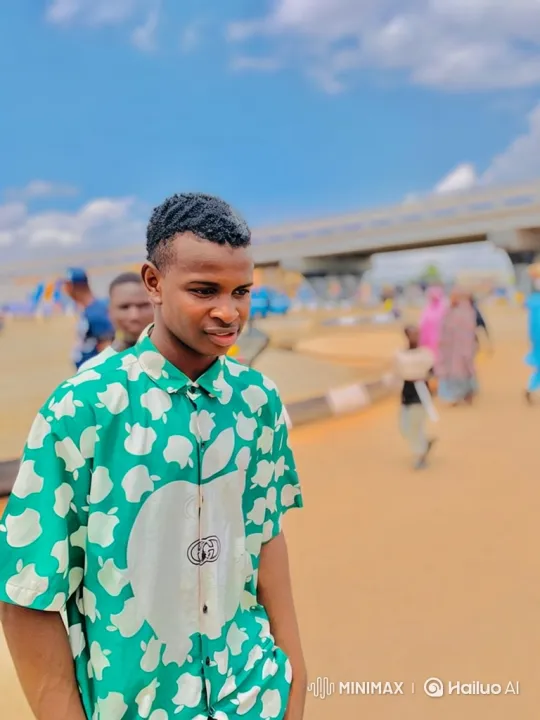 Young Man in Green Shirt Smiles Outdoors – AI Generated Video | Hailuo AI