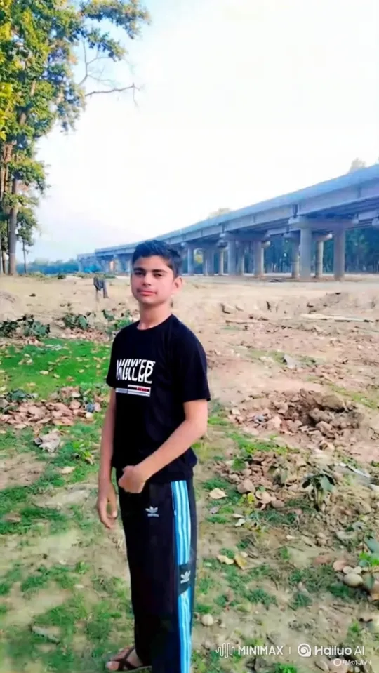 Young Man in Graphic Tee Amidst Nature and Industry – AI Generated Video | Hailuo AI