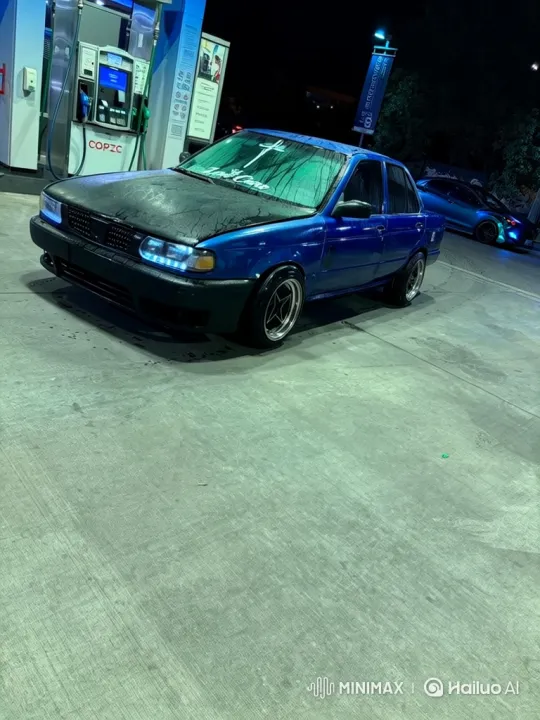 Custom Blue Sedan Lowers at Night Gas Station – AI Generated Video | Hailuo AI