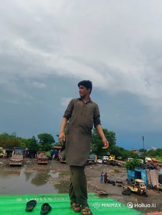 Young Man Reflects Amid Industrial Yard's Grey Skies – AI Generated Video | Hailuo AI