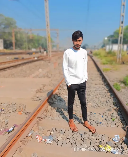 Young Man Reflects on Railway Tracks in Sunlit Day – AI Generated Video | Hailuo AI