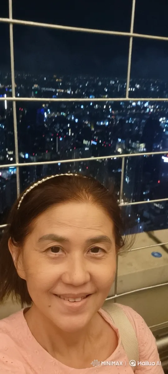 Woman Enjoys Night View from Revolving Skyscraper Deck – AI Generated Video | Hailuo AI