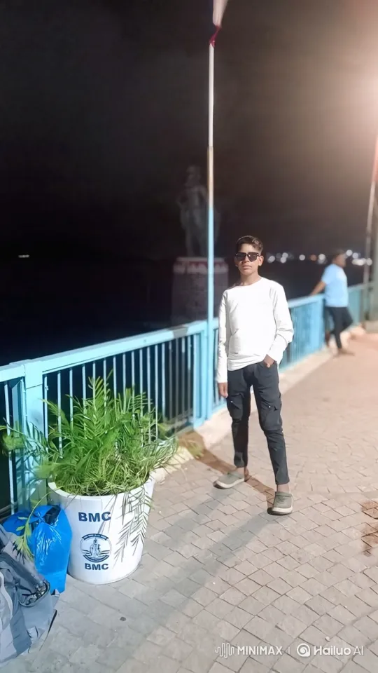 Young Man Poses by Water at Night with Gentle Breeze – AI Generated Video | Hailuo AI