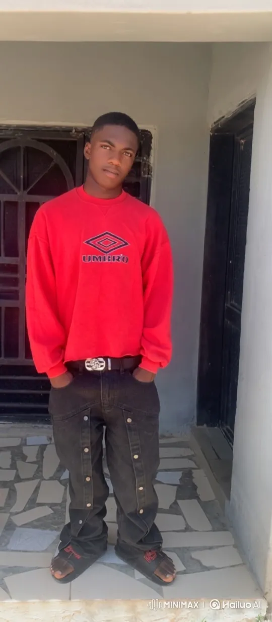 Young Man in Red Sweatshirt Stands Still看向摄像机 – AI Generated Video | Hailuo AI