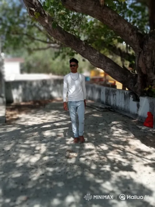 Young Man Walks Confidently in Shaded Park Setting – AI Generated Video | Hailuo AI