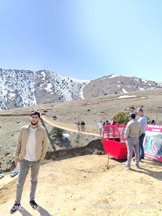 Young Man in Mountains Amidst Snowy Landscape – AI Generated Video | Hailuo AI