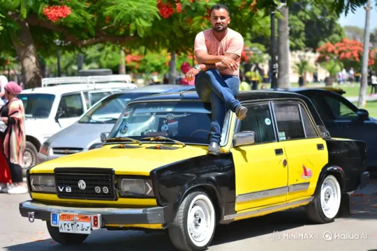 Man Poses Proudly on Custom Car in Blossoming Park – AI Generated Video | Hailuo AI