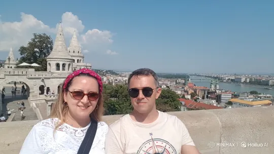 Couple Poses for Photo in Historic City Panorama – AI Generated Video | Hailuo AI