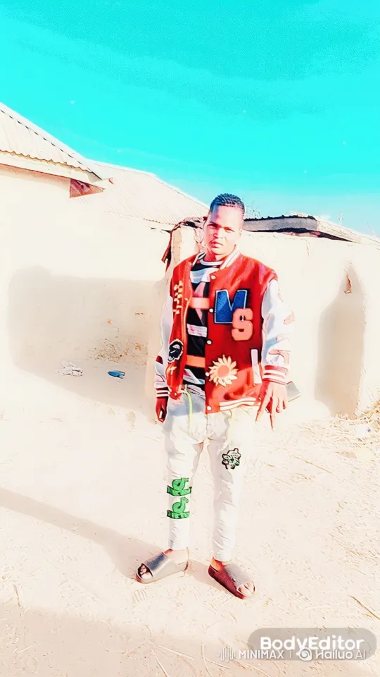 Young Man Poses in Striking Jacket Under Cyan Sky – AI Generated Video | Hailuo AI