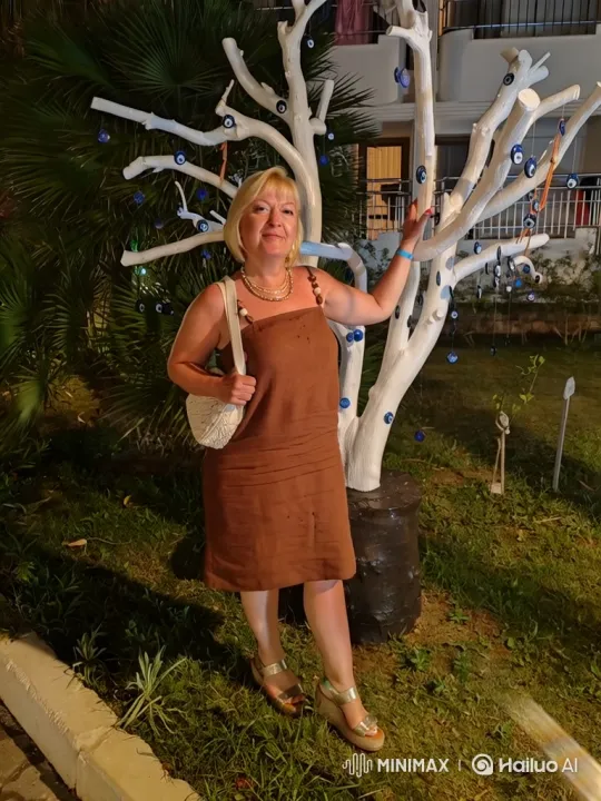 Woman in Garden Admires Nighttime Decorated Tree – AI Generated Video | Hailuo AI