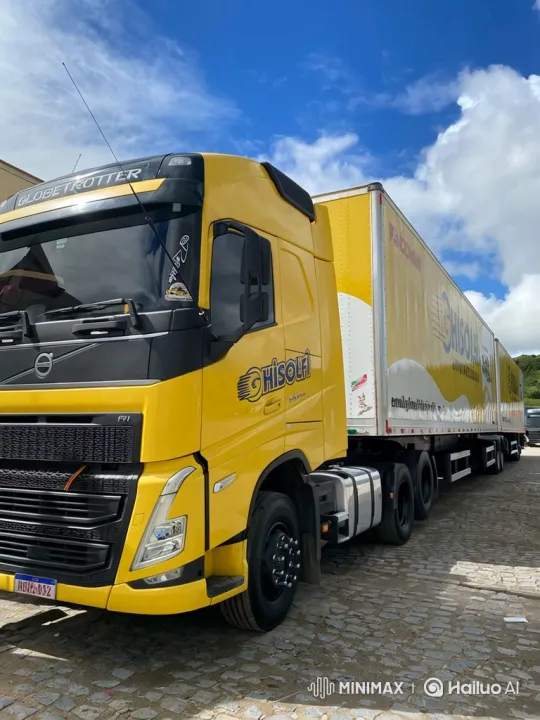 Yellow Volvo Truck Drives Across Cobblestone Lot – AI Generated Video | Hailuo AI