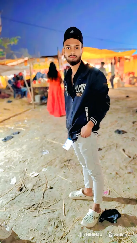 Young Man Stands at Nocturnal Outdoor Fair – AI Generated Video | Hailuo AI