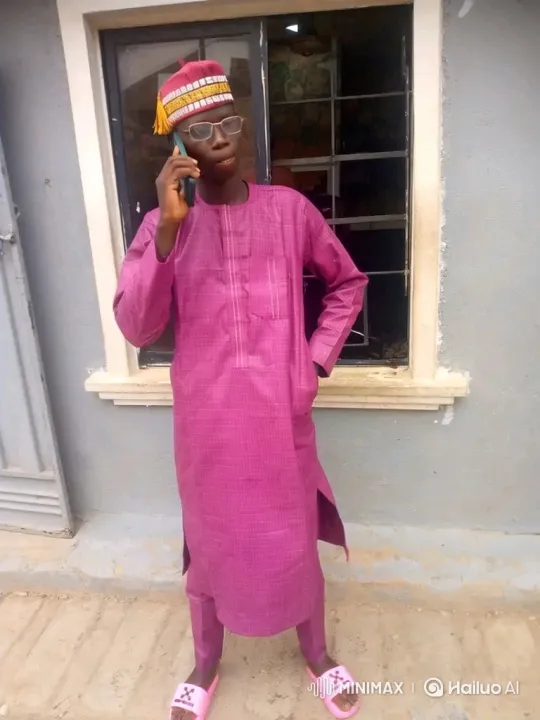 Young Man in Magenta Discusses on Phone Outdoors – AI Generated Video | Hailuo AI