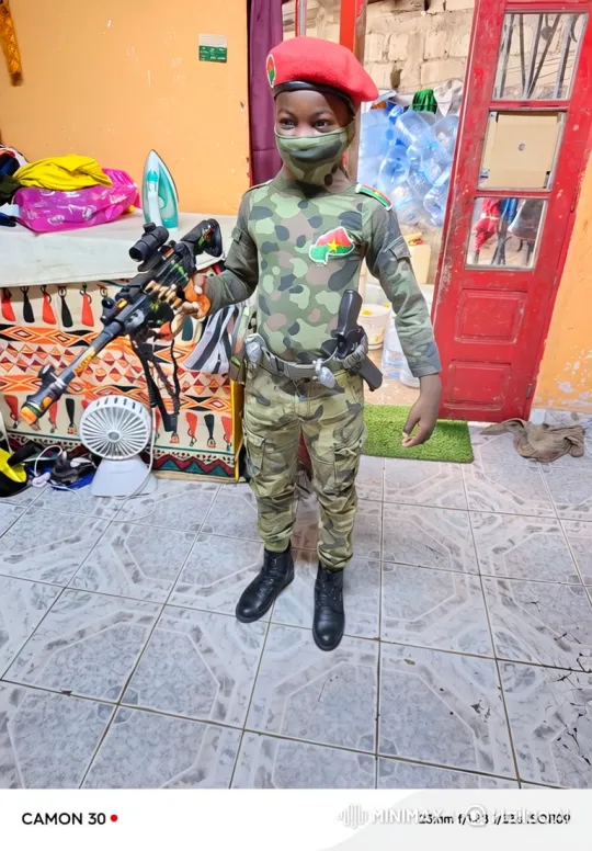 Young Child in Soldier Costume With Determined Gaze – AI Generated Video | Hailuo AI