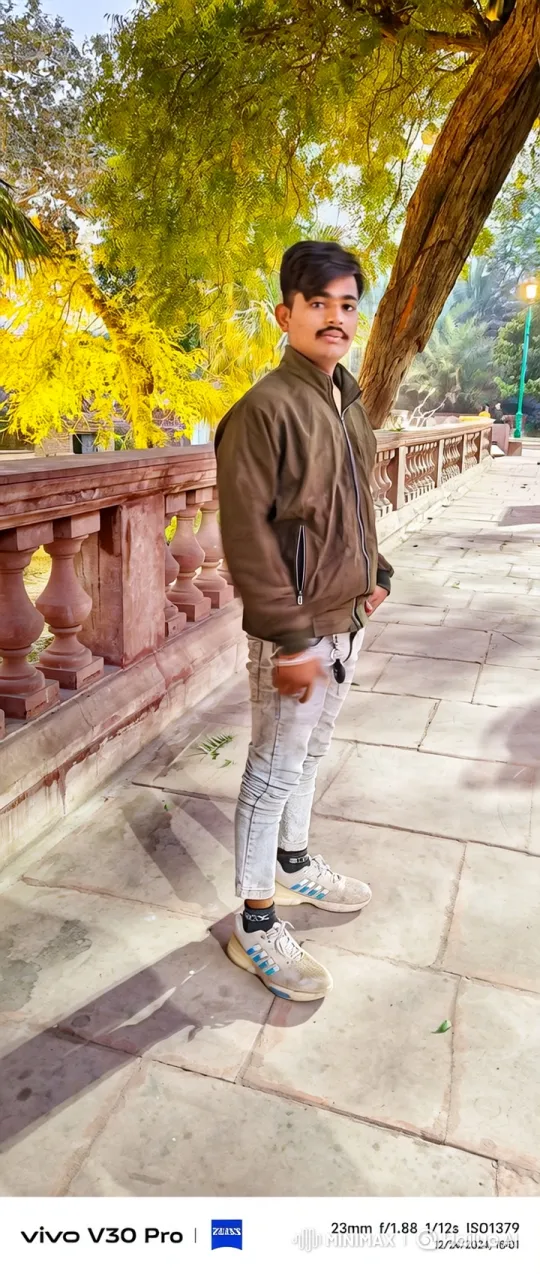 Young Man Smiles Gently in Peaceful Park Setting – AI Generated Video | Hailuo AI