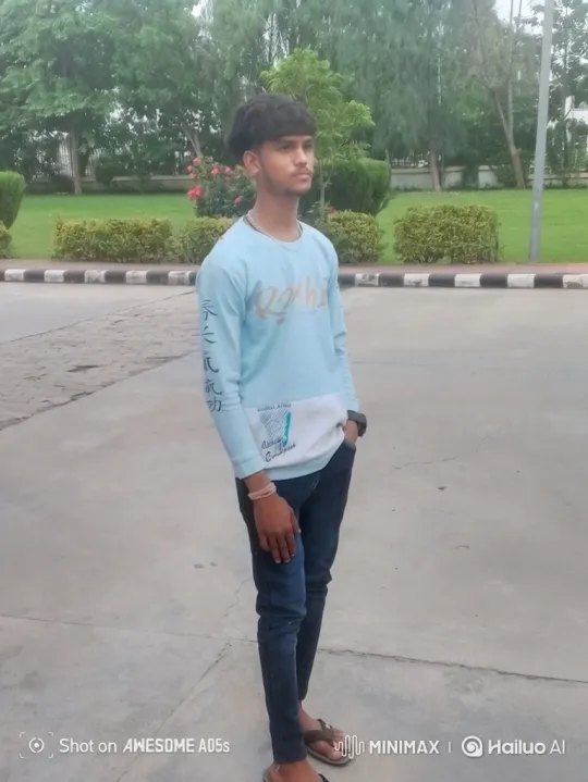 Young Man Smiles Gently in Park Setting – AI Generated Video | Hailuo AI