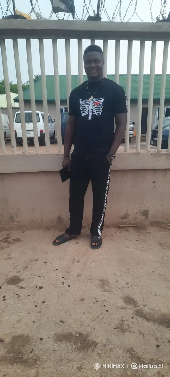 Young Man with Skeleton Shirt by Fence - Camera Movement Study – AI Generated Video | Hailuo AI