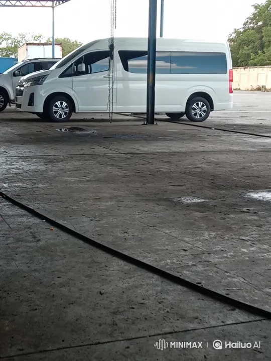 White Van with Adjustable Suspension Lowers in Workshop – AI Generated Video | Hailuo AI