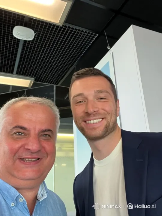 Two Men Shake Hands in Modern Indoor Setting – AI Generated Video | Hailuo AI
