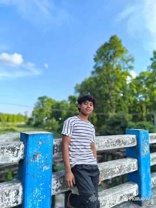 Young Man on Bridge: Serene Smile Amidst Nature – AI Generated Video | Hailuo AI