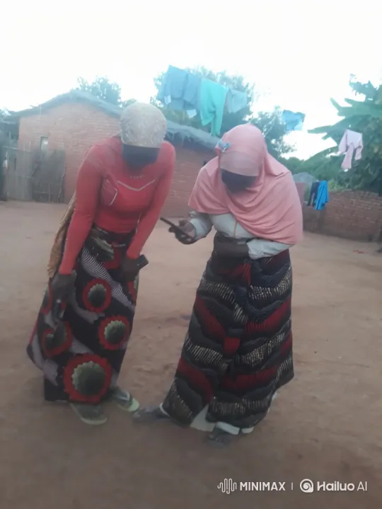 Two women share a smartphone in rural setting – AI Generated Video | Hailuo AI