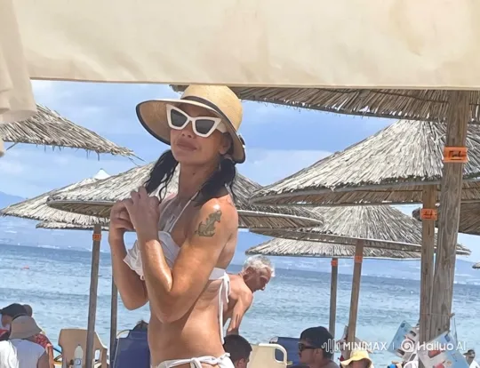 Stylish Woman on Bustling Beach with Serene Pose – AI Generated Video | Hailuo AI