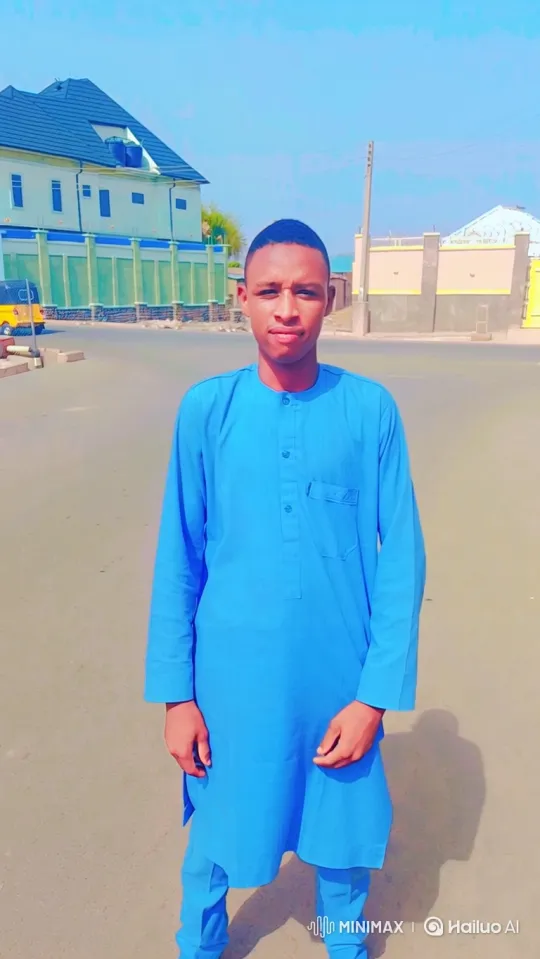 Young Man in Blue Stands Calmly in Sunlit Street – AI Generated Video | Hailuo AI