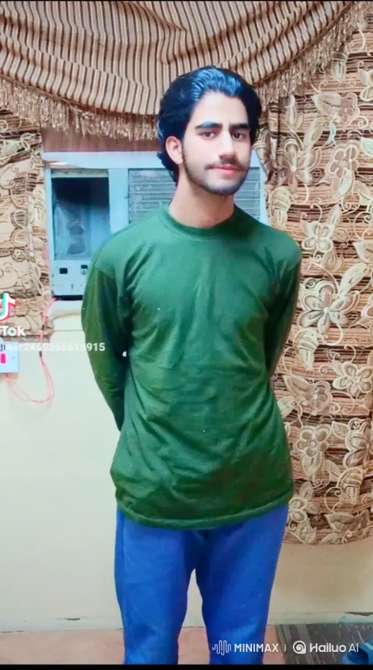Young Man in Green Shirt Stands Calmly Before Camera – AI Generated Video | Hailuo AI