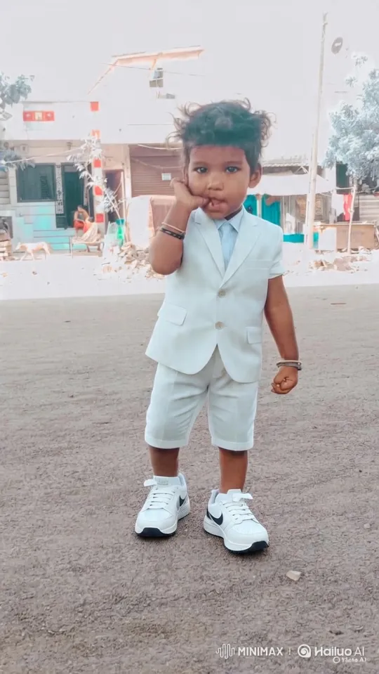 Young Boy in White Suit Poses Confidently – AI Generated Video | Hailuo AI