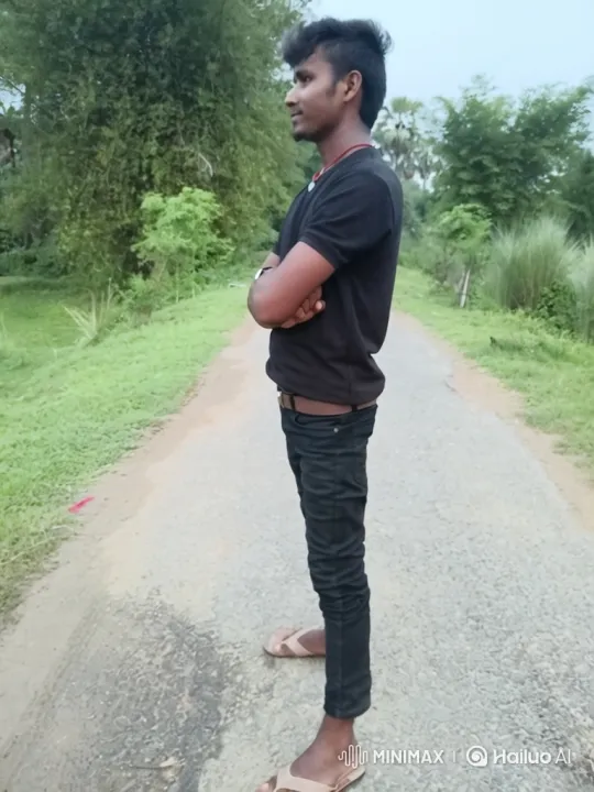 Young Man Reflects on Rural Road with Bamboo Background – AI Generated Video | Hailuo AI