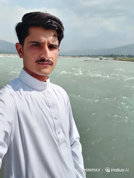 Young Man Stands by a River with Moving Water and Clouds – AI Generated Video | Hailuo AI