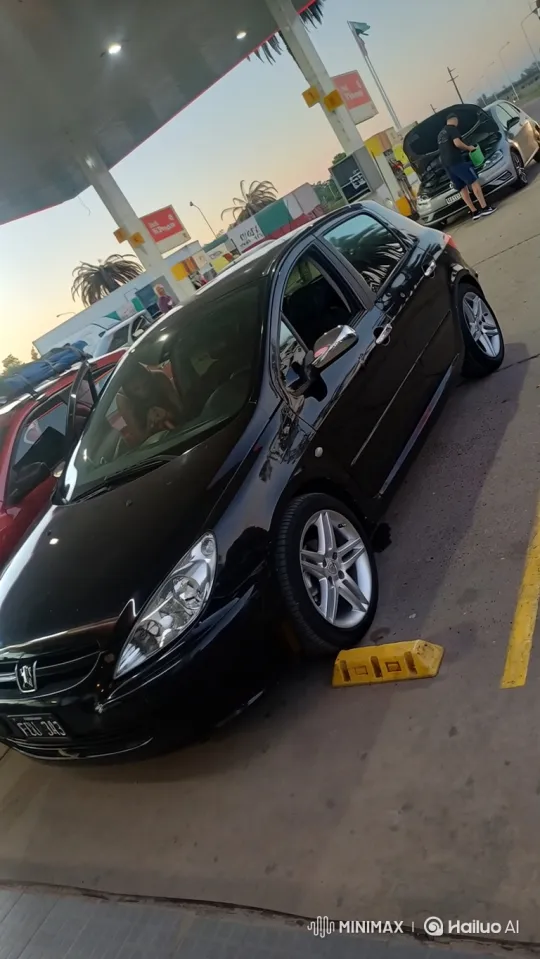 Glossy Black Hatchback Lowers Gracefully at Twilight Gas Station – AI Generated Video | Hailuo AI
