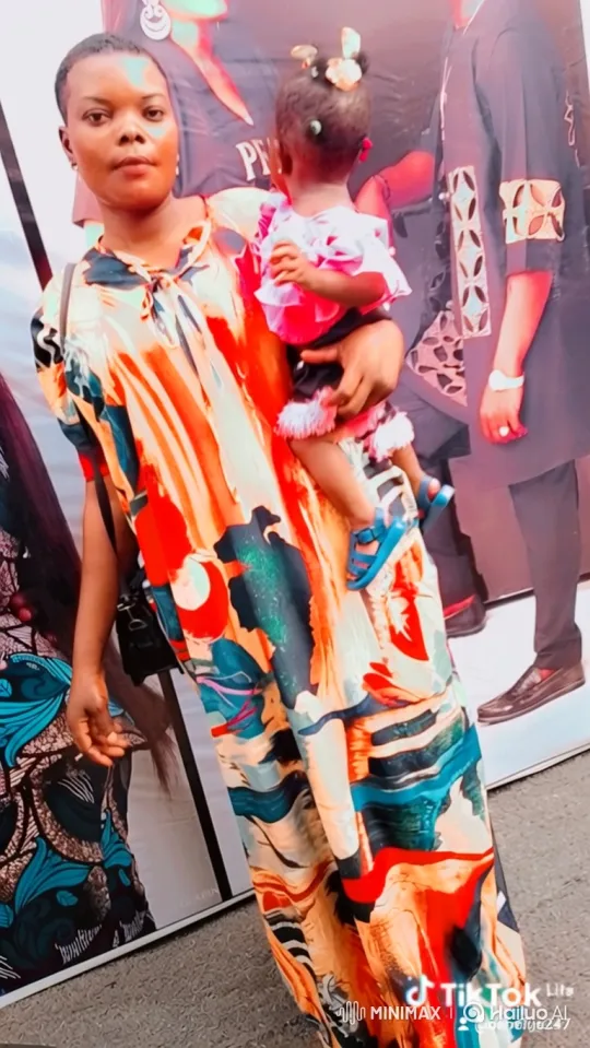Woman with Child in Colorful Dress - Close-up Embrace – AI Generated Video | Hailuo AI