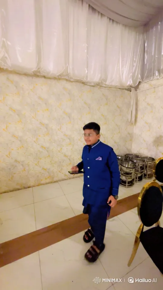 Young Boy in Formal Attire Walks Through Event Hall – AI Generated Video | Hailuo AI