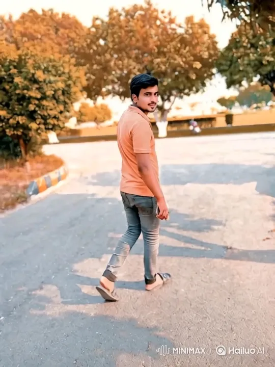 Young Man in Orange Shirt Walks Down Path – AI Generated Video | Hailuo AI