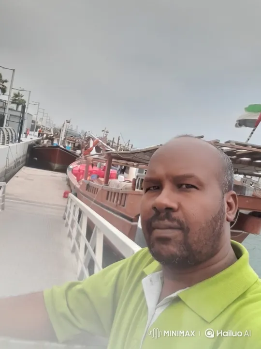 Man in Green Polo Films Waterfront Tracking Shots – AI Generated Video | Hailuo AI