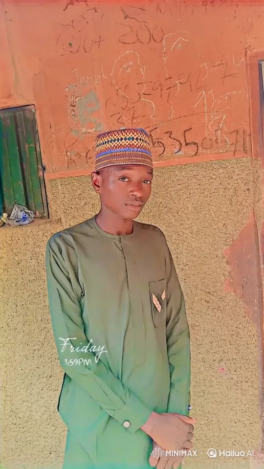 Young Man in Olive-Green Tunic Stands Calmly Before a Wall – AI Generated Video | Hailuo AI