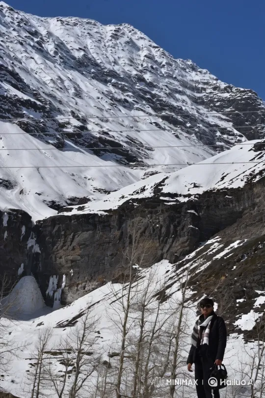Person Amidst Snowy Mountain Panorama – AI Generated Video | Hailuo AI