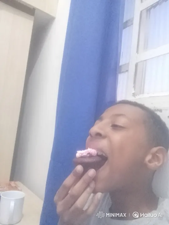 Boy Enjoying Chocolate Cupcake with Pink Frosting – AI Generated Video | Hailuo AI