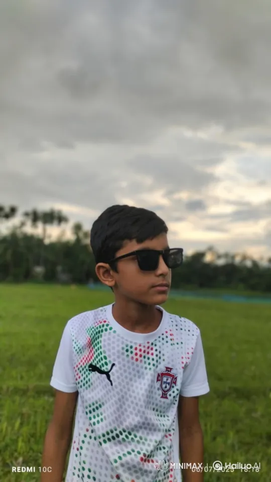 Boy in Sunglasses Smiles at Camera in Serene Field – AI Generated Video | Hailuo AI