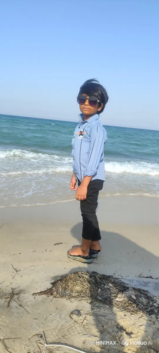 Boy Catches Tiny Fish on Sandy Beach – AI Generated Video | Hailuo AI