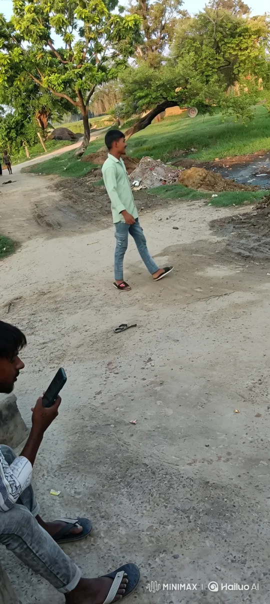 Young Man on Phone Amidst Quiet Outdoor Scene – AI Generated Video | Hailuo AI