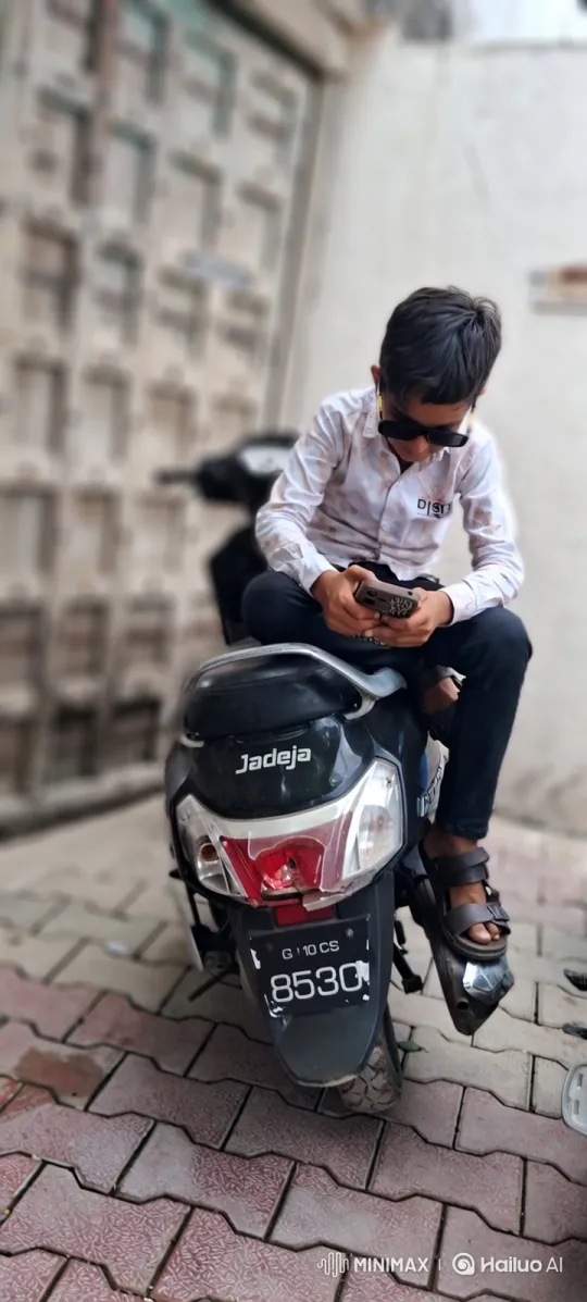 Young Boy on Scooter with Smartphone – AI Generated Video | Hailuo AI