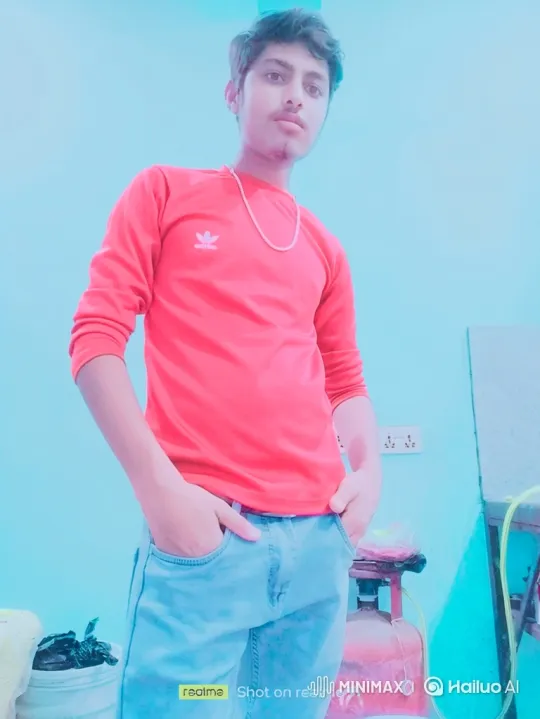 Young Man in Red Shirt Stands Calmly in Blue-Tinted Room – AI Generated Video | Hailuo AI