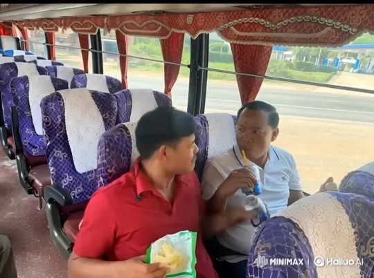 Two Men Sharing Snacks and Affection on a Bus – AI Generated Video | Hailuo AI