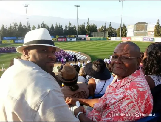 Two Men Enjoying a Stadium Event with Warm Smiles – AI Generated Video | Hailuo AI