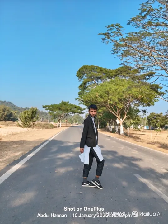 Young Man Poses on Rural Road in Sunny Day – AI Generated Video | Hailuo AI