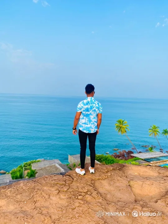 Contemplative Man on Cliff Overlooking Vast Ocean – AI Generated Video | Hailuo AI